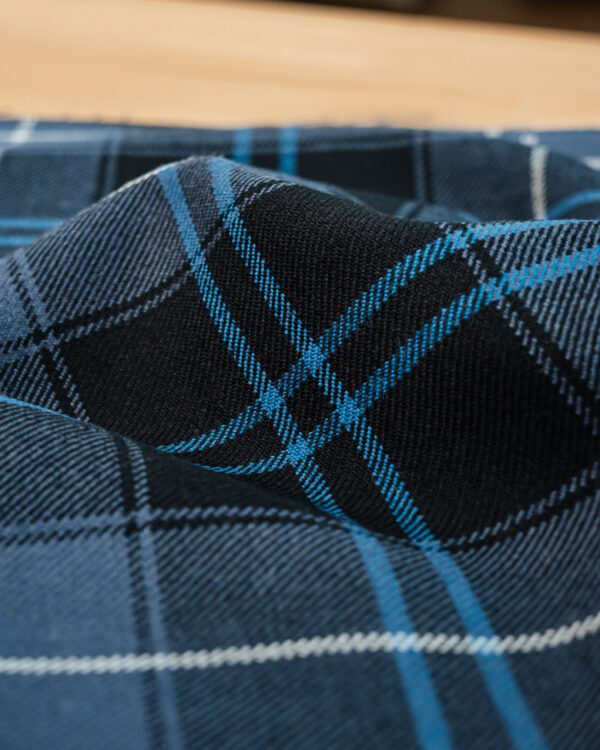 Tartan grey and blue with lighter blue stripe.